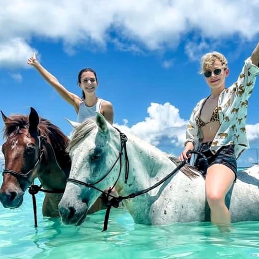 Horse riding along turquoise waters Zanzibar beach
